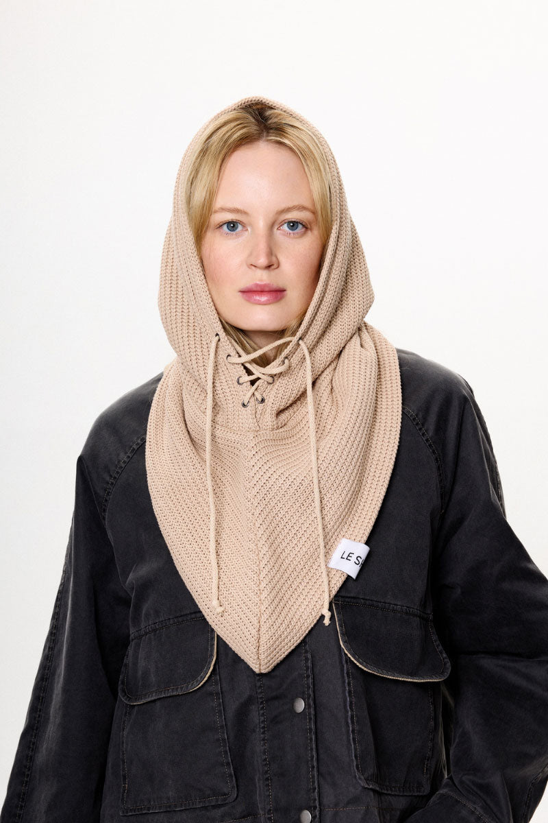 Beige LE SH KA balaclava hat worn over the head, made of soft fabric, designed for warmth and full face coverage.