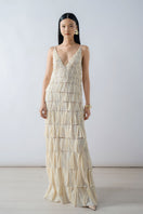 Beige deep V-neck tiered pleated maxi dress by DOC BAN, flowing fabric with layered design and elegant style.
