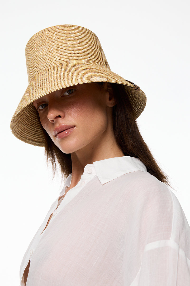 Beige bucket hat from LE SH KA featuring a casual, wide-brim design suitable for outdoor wear.