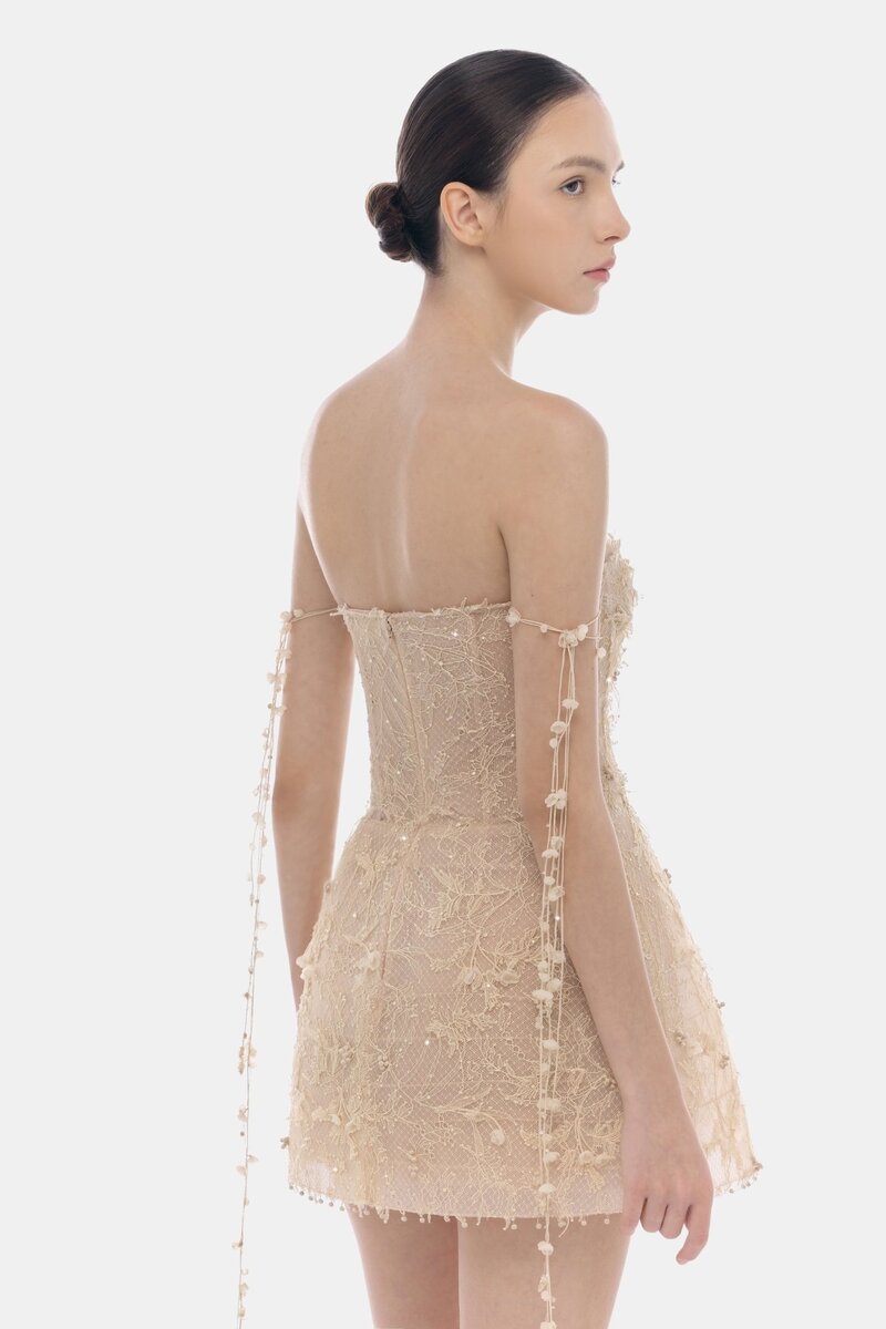 Beige floral string mini dress by Montsand featuring a fitted silhouette and delicate floral pattern.