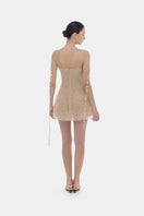 Beige floral string mini dress by Montsand, featuring lightweight fabric, adjustable straps, and a fitted silhouette.