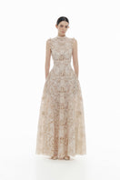 Beige flower beaded gown by Montsand featuring intricate beadwork and flowing maxi dress style.