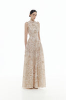 Beige flower beaded gown by Montsand, featuring intricate beadwork and flowing fabric, elegant maxi dress for special occasions.