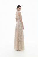 Beige flower beaded gown by Montsand featuring intricate beadwork, flowy fabric, and elegant maxi dress silhouette.