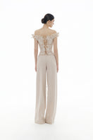 Beige flower beaded corset top by Montsand paired with matching trousers, stylish and elegant women's fashion outfit.