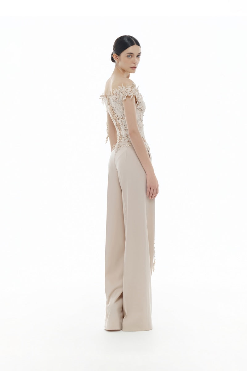 Beige beaded corset top from Montsand, shown with matching trousers, featuring floral details and stylish design.
