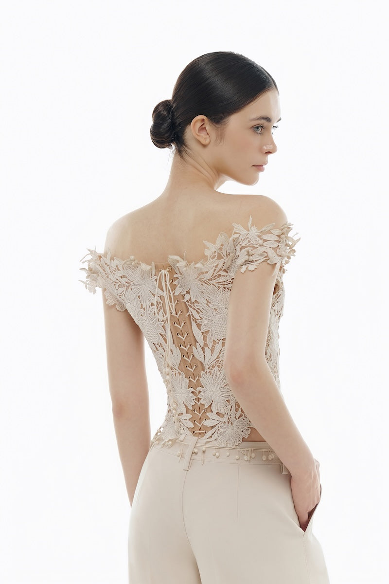 Beige flower beaded corset top from Montsand, styled with matching trousers, featuring intricate beadwork and floral details.