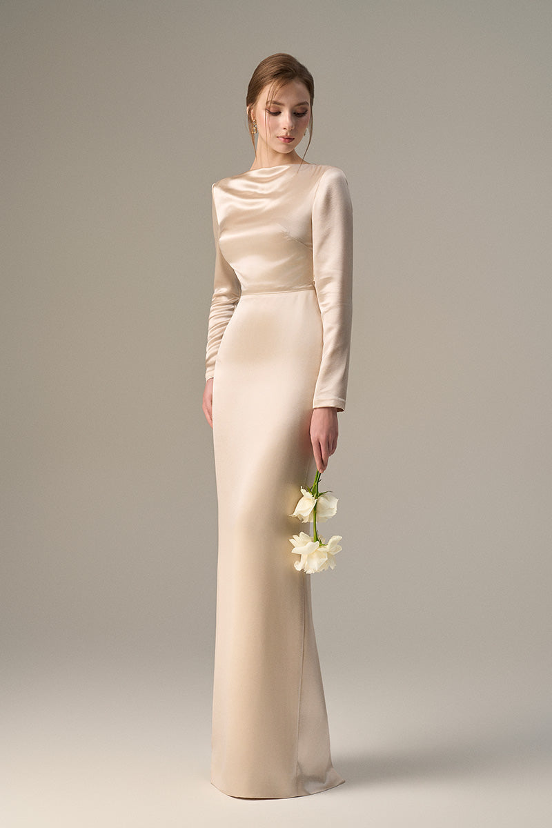 Beige satin silk maxi dress with long sleeves, draped back, and tie detail, stylish I.H.F dress for elegant occasions.