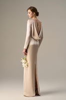 Beige satin silk gown by I.H.F with long sleeves, draped back, and tie detail, showcasing elegant, flowing fabric.