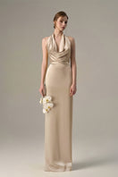 Beige satin silk halter gown with pleated detailing, designed by I.H.F, showcasing elegant fabric and sophisticated style.