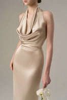 Beige satin silk halter gown with pleated detailing, elegant evening dress by I.H.F, showcased on a mannequin.