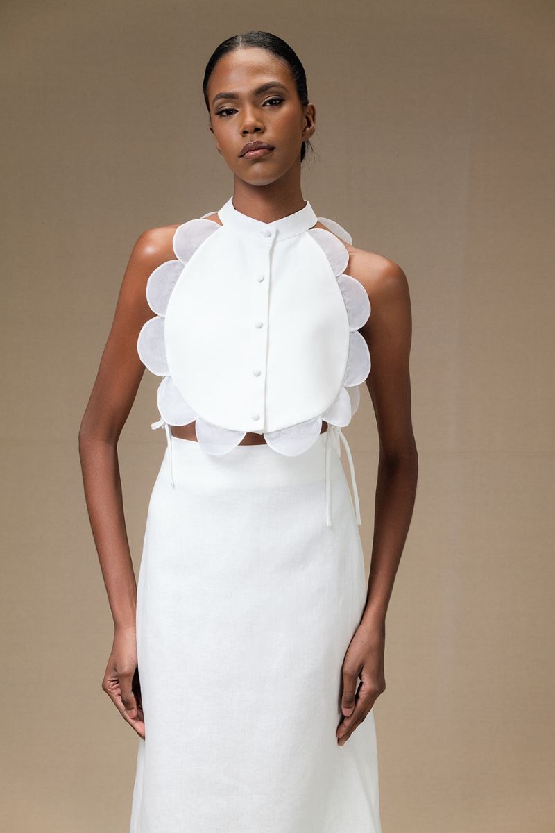 Ivory Bella bib top by Ana + Maria, featuring a stylish, soft fabric design perfect for casual or elegant outfits.