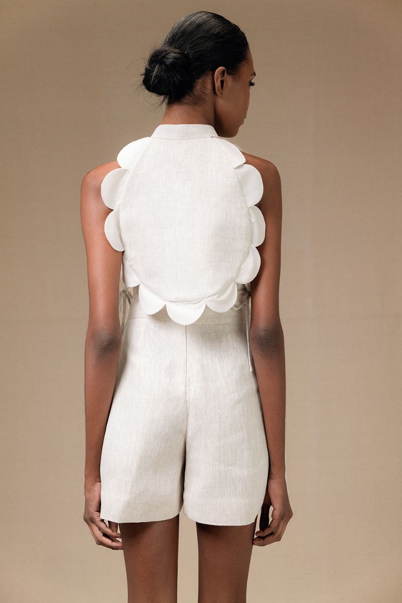 ANA + MARIA Bella Bib top in sand color, showcasing a stylish sleeveless blouse with a relaxed fit and soft fabric.