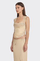 Cream lace corset top with draped design from Stolen Stores, featuring sheer fabric and intricate lace detailing.