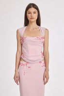 Pink lace draped corset top from Stolen Stores, featuring sheer fabric and intricate lace detailing.