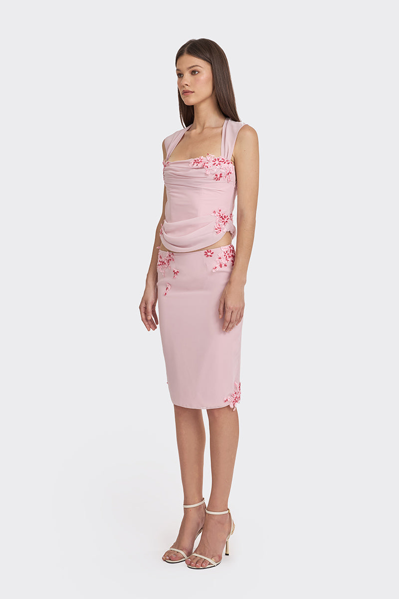 Pink lace draped corset top by Stolen Stores, featuring sheer fabric and elegant detailing.