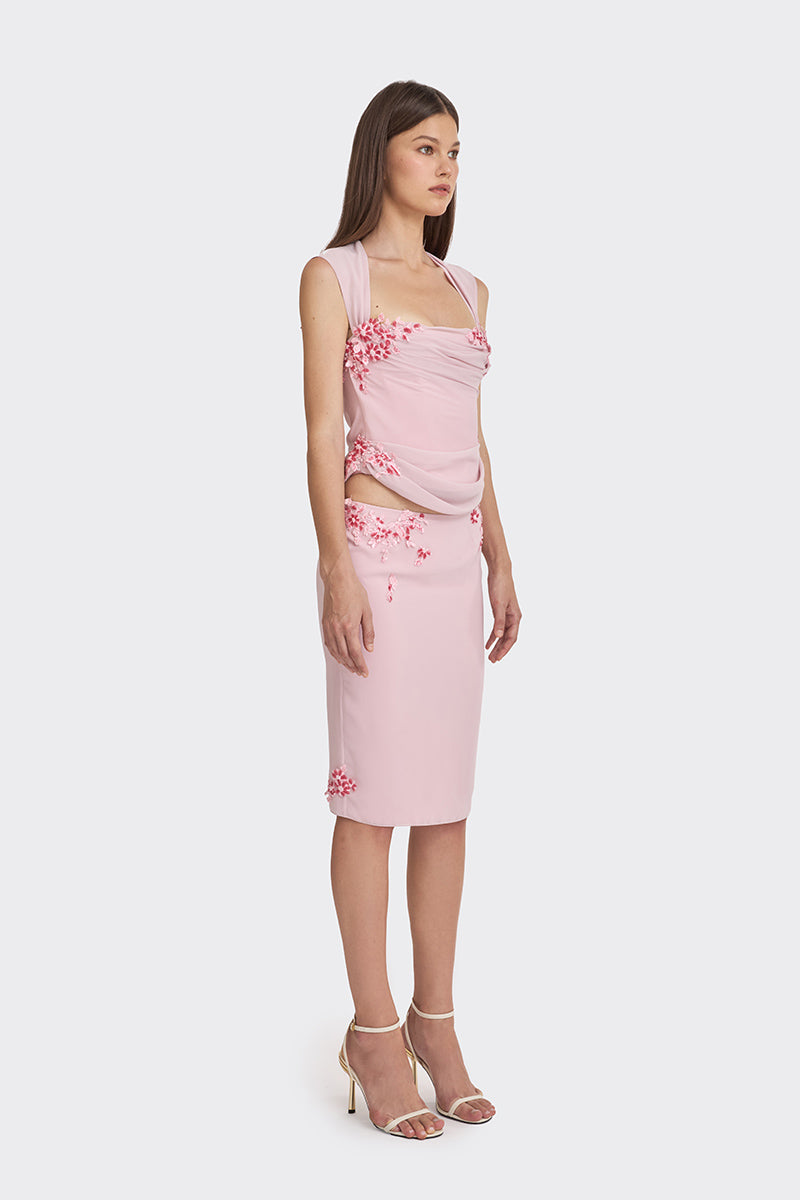 Pink lace corset top with draped design from Stolen Stores, featuring sheer fabric and intricate lace detailing.
