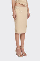 Cream lace knee-length midi skirt from Stolen Stores, featuring intricate lace details and a classic silhouette.