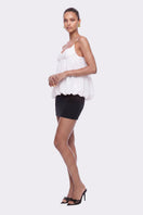 White Bellina Top by Nana Jacqueline featuring a bubble hem, shown on a model with a casual, stylish look.