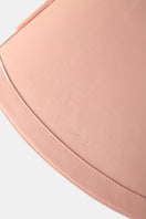 Pink POELLE Bell mini bag with top handle, showcasing a sleek and stylish design perfect for casual or evening outings.