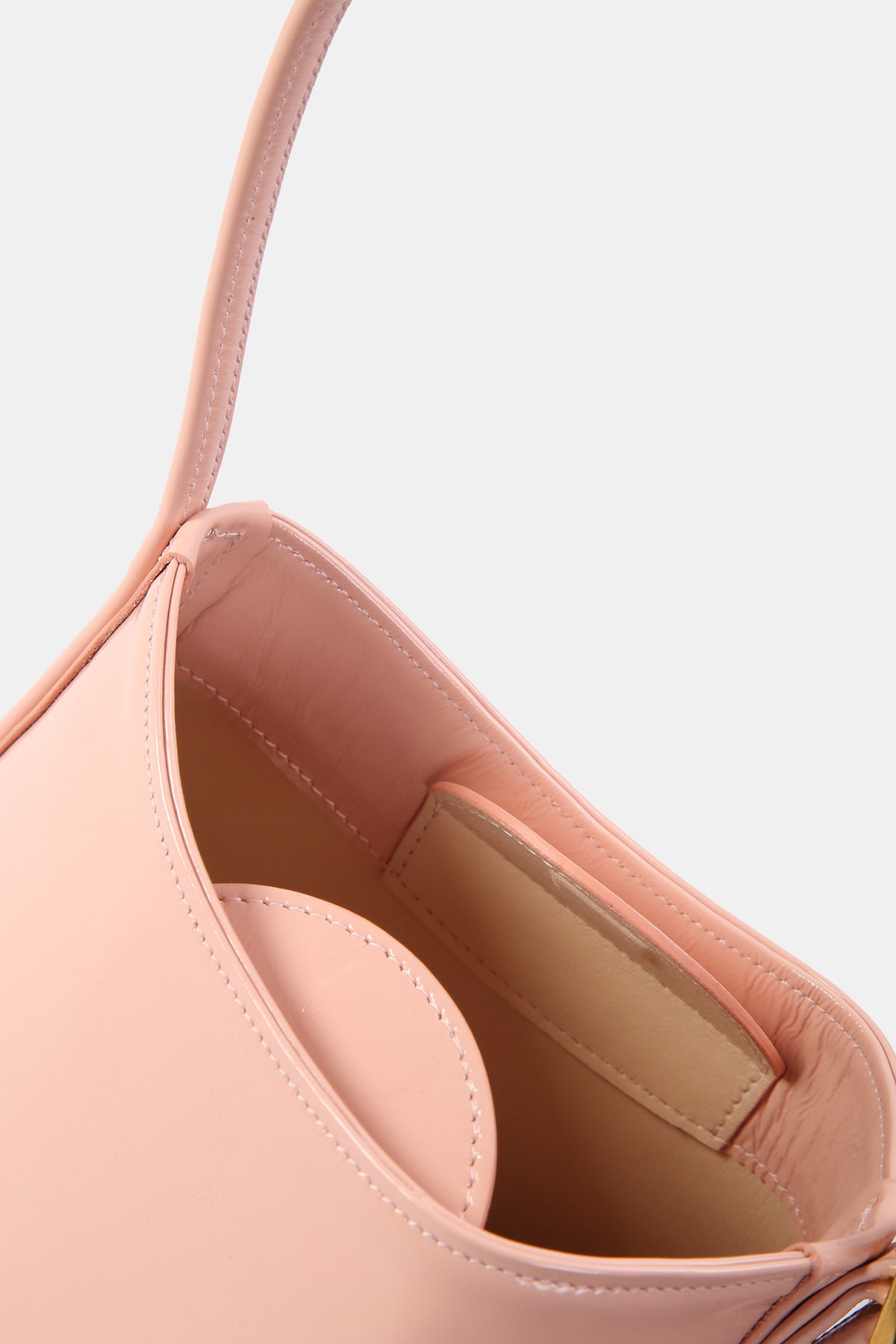Pink POELLE Bell mini bag with top handle, featuring a compact design and sleek style, perfect for everyday use.