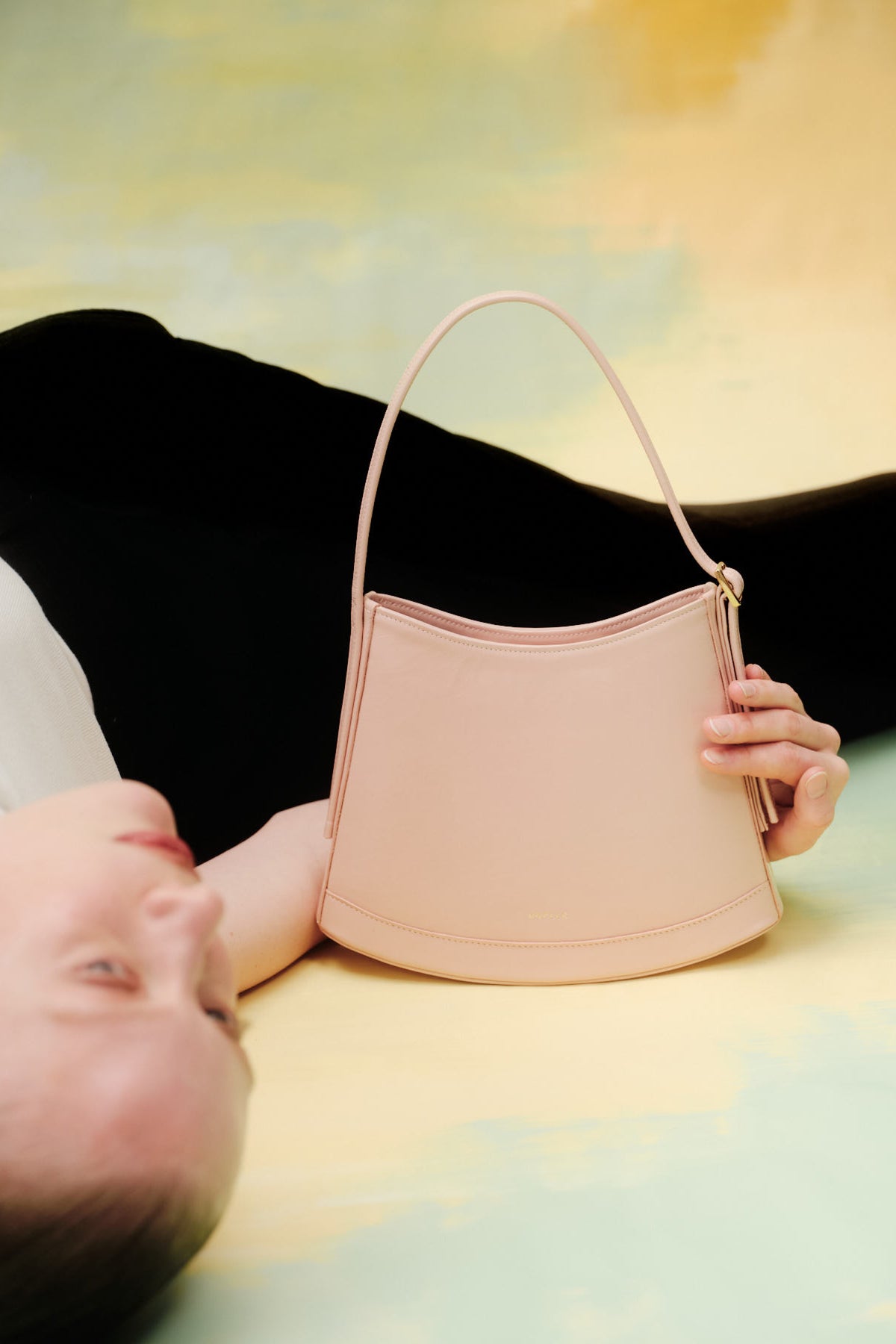 Pink POELLE Bell mini bag with top handle, featuring a compact and stylish design perfect for everyday use.