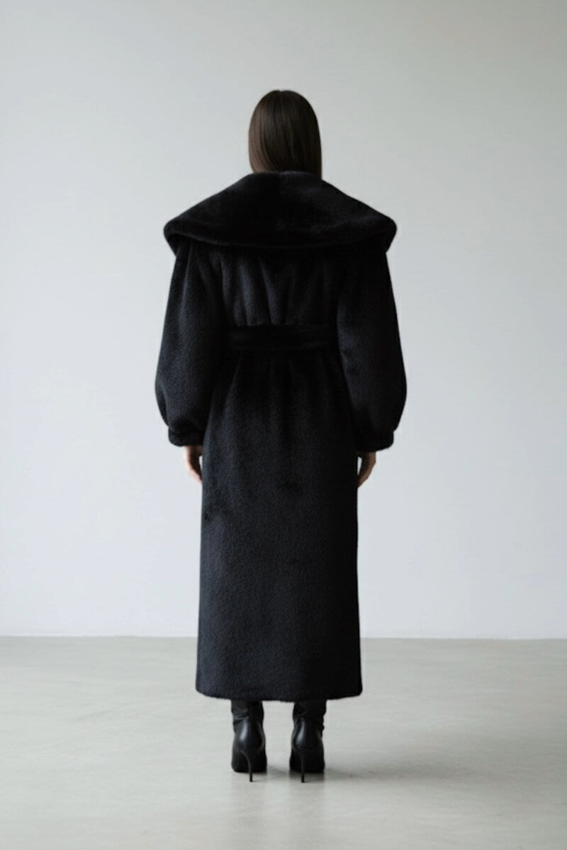 Black faux fur coat by Fortini, stylish old money-inspired design, shown hanging on a hanger with a plush texture.