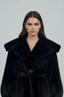 Black faux fur coat by Fortini featuring plush texture and classic design, styled for a sophisticated look.
