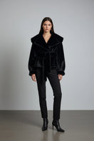 Black faux fur jacket by Fortini from the Old Money collection, shown in a stylish image highlighting its luxurious texture and design.
