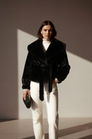Black faux fur jacket from Fortini's Old Money collection, stylishly displayed, showcasing plush texture and classic design.