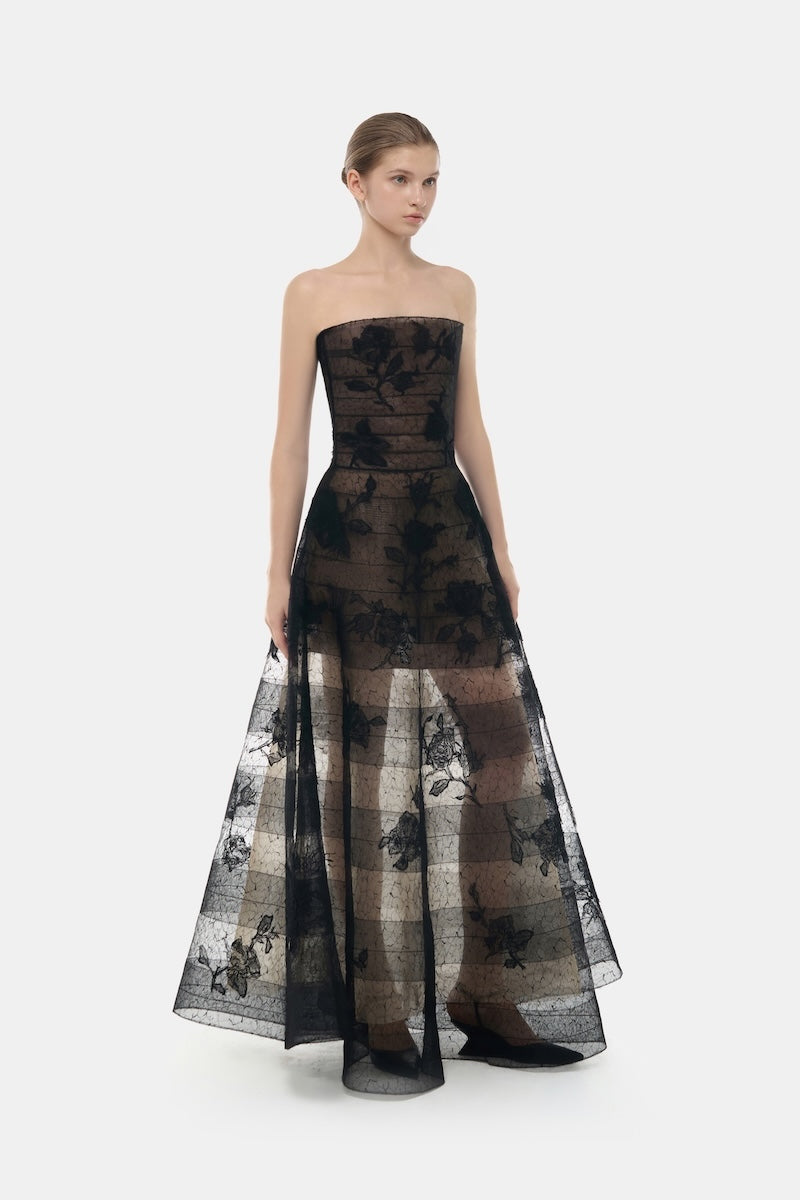 Black CULT MIA X Montsand floral applique maxi dress with long flowing fabric and elegant design, shown on a model.