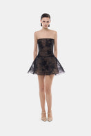 Black floral appliqué mini dress by Montsand, featuring delicate floral embroidery and a fitted silhouette.