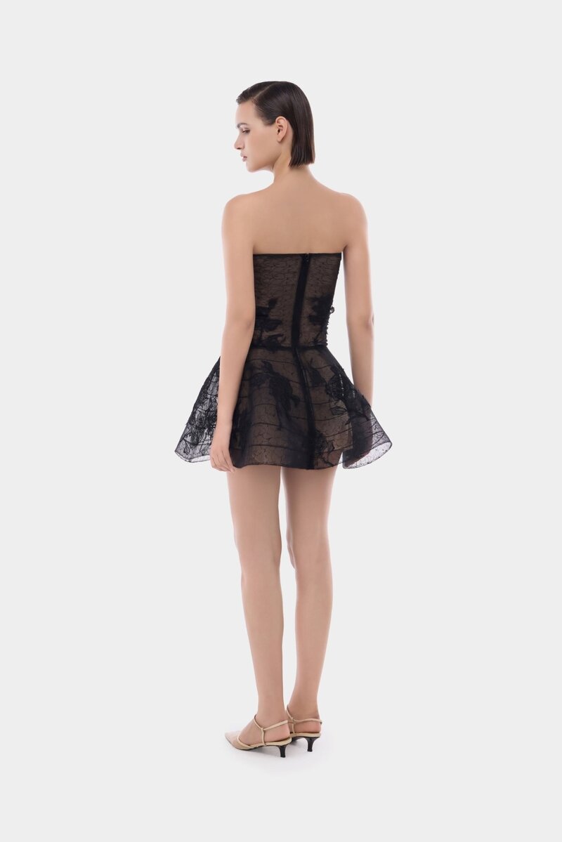 Black floral appliqué mini dress by Montsand, featuring intricate floral embroidery on a sleek black fabric.