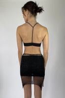 Back view of Natalia Fedner's black Midas mini skirt with slip, showcasing its sleek design and fitted silhouette.