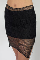 Side view of a black Midas mini skirt with slip by Natalia Fedner, showcasing its sleek design and fitted silhouette.
