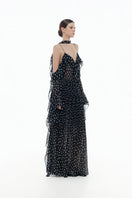 Black off-shoulder flowing maxi dress by Montsand, featuring a relaxed fit and elegant design, shown on a model.