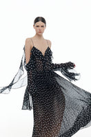 Black off-shoulder flowing maxi dress by Montsand, featuring a relaxed fit and elegant drape, displayed on a mannequin.