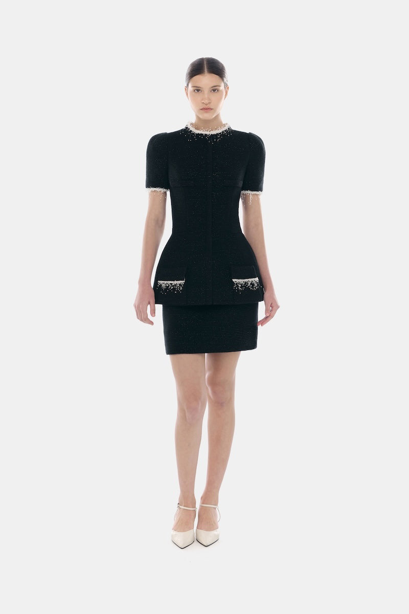 Black short sleeve tweed blazer by Montsand, tailored fit with classic collar and textured fabric, paired with a matching tweed skirt.