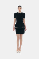 Black short sleeve tweed blazer by Montsand, shown layered over a matching tweed skirt, stylish and tailored for a chic look.
