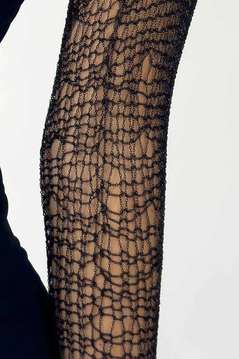 Close-up of Natalia Fedner black chain bolero shrug cardigan with intricate chain details and textured fabric.