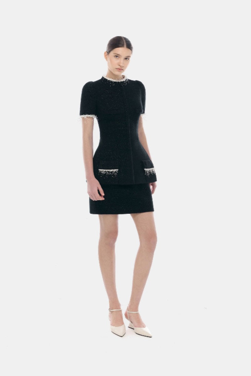 Black tweed mini skirt from Montsand, featuring a classic textured fabric and a stylish, fitted silhouette.