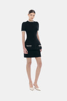 Black tweed mini skirt by Montsand, showing a fitted high-waist design with textured tweed fabric and button details.