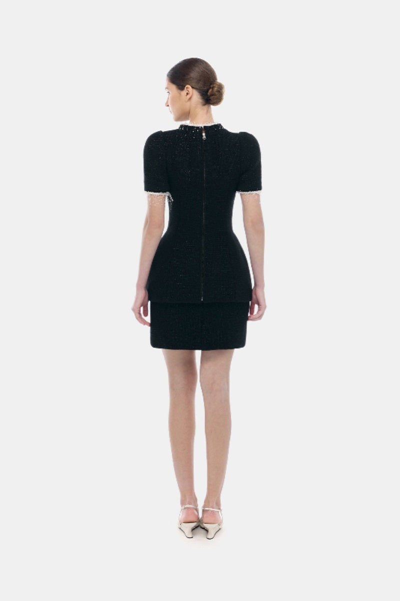 Black tweed mini skirt by Montsand, featuring a classic textured fabric and tailored fit, designed for a stylish look.