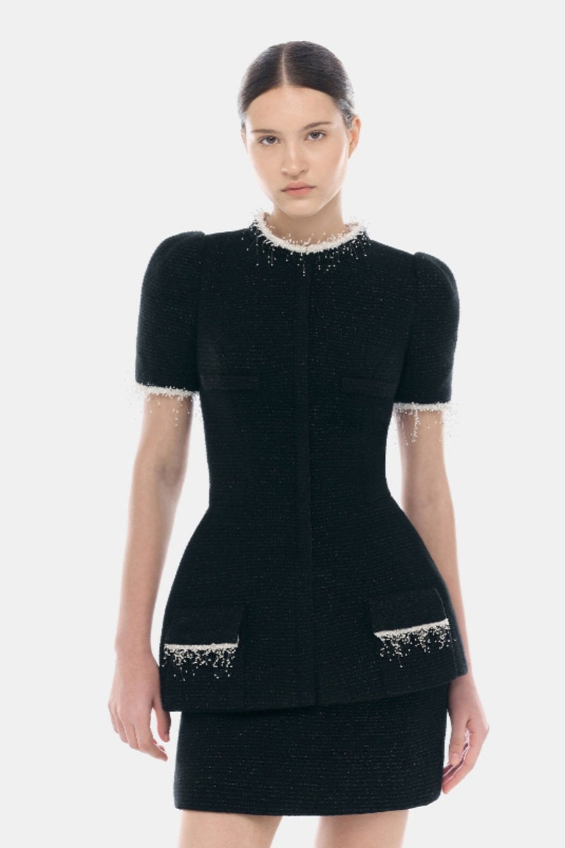 Black tweed mini skirt by Montsand featuring a classic textured fabric and a fitted silhouette.