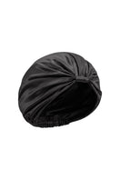 Black silk sleep cap for women by MANITO, featuring a blooming floral design, designed for comfortable nighttime wear.