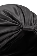 Black silk sleep cap for women by MANITO, featuring a blooming floral design, designed for comfortable nighttime wear.