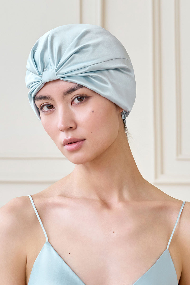 Blue silk sleep cap for women by MANITO, soft and comfortable hat with blooming floral design for restful sleep.
