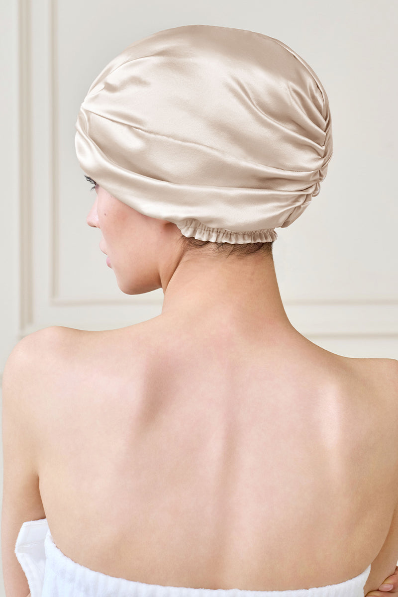 Manito blooming women's silk sleep cap showing a soft, luxurious pink silk hat with floral embroidery for comfortable sleep.