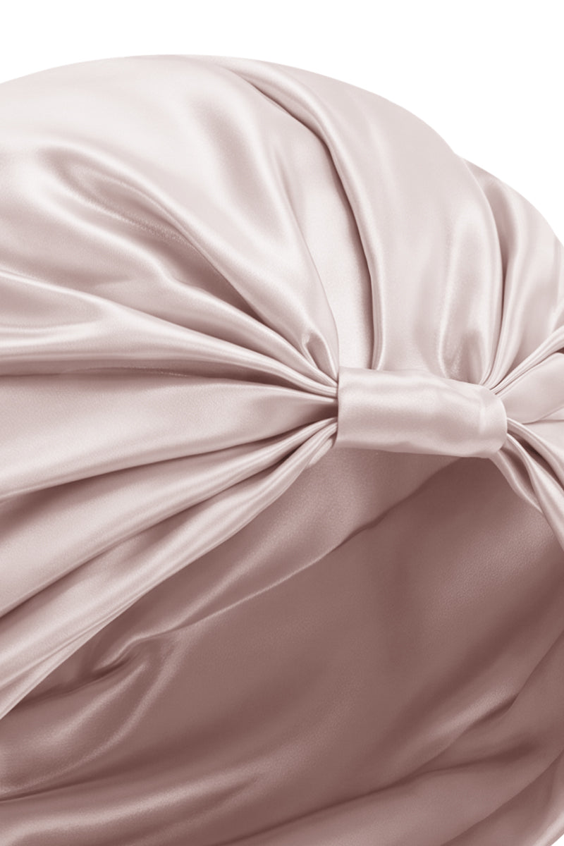 Pink silk sleep cap for women by MANITO, featuring a blooming floral design, soft and comfortable for restful sleep.