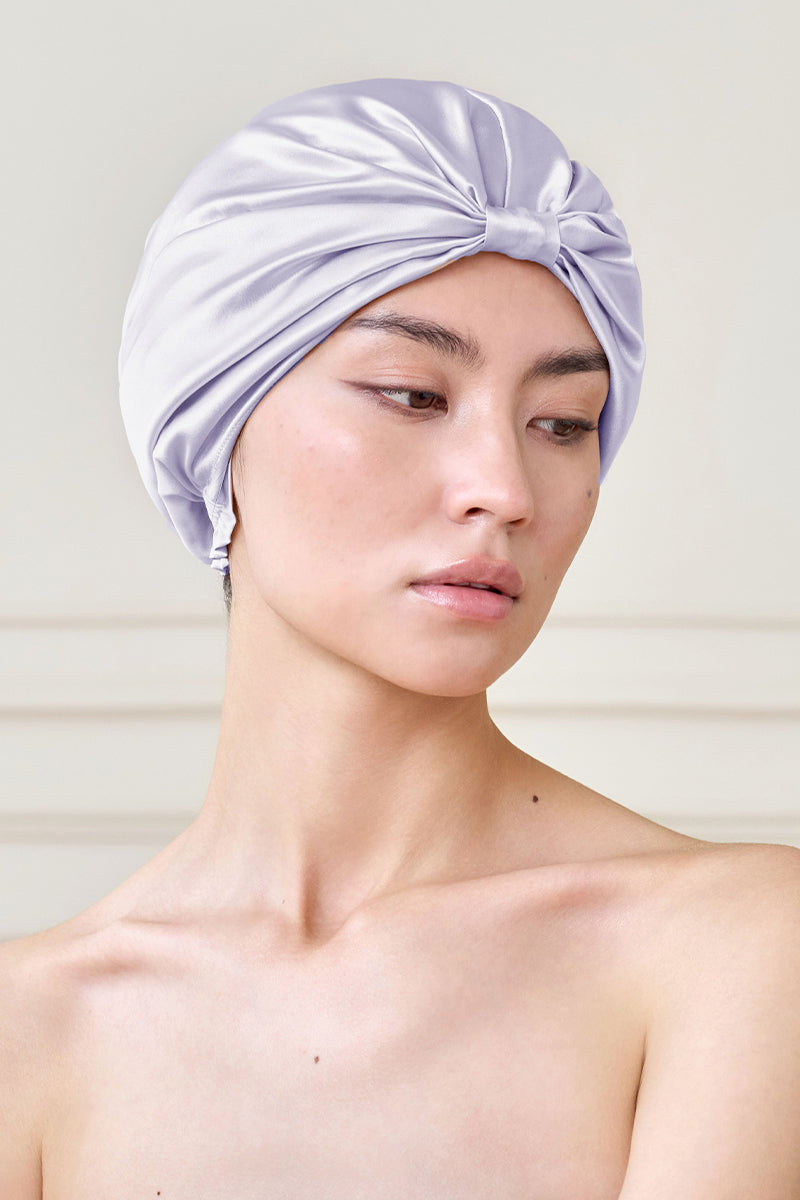 Purple silk sleep cap for women by MANITO, featuring a blooming floral design, designed for comfortable nighttime wear.